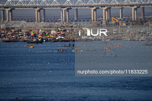 People take boat rides at Sangam, the confluence of the rivers Ganges, Yamuna, and Saraswati, in Prayagraj, India, on December 4, 2024. 