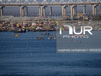 People take boat rides at Sangam, the confluence of the rivers Ganges, Yamuna, and Saraswati, in Prayagraj, India, on December 4, 2024. (