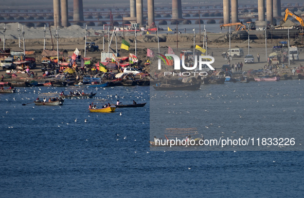 People take boat rides at Sangam, the confluence of the rivers Ganges, Yamuna, and Saraswati, in Prayagraj, India, on December 4, 2024. 