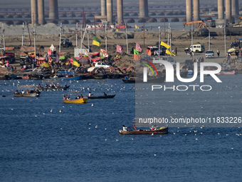 People take boat rides at Sangam, the confluence of the rivers Ganges, Yamuna, and Saraswati, in Prayagraj, India, on December 4, 2024. (