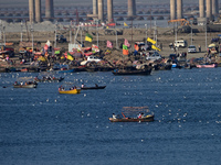 People take boat rides at Sangam, the confluence of the rivers Ganges, Yamuna, and Saraswati, in Prayagraj, India, on December 4, 2024. (