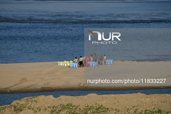 Workers fill sandbags on the banks of Sangam, the confluence of the Rivers Ganges, Yamuna, and mythical Saraswati, ahead of the Maha Kumbh M...