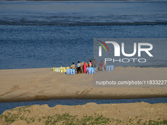 Workers fill sandbags on the banks of Sangam, the confluence of the Rivers Ganges, Yamuna, and mythical Saraswati, ahead of the Maha Kumbh M...