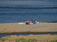 Workers fill sandbags on the banks of Sangam, the confluence of the Rivers Ganges, Yamuna, and mythical Saraswati, ahead of the Maha Kumbh M...