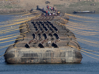 Labourers build a floating pontoon bridge at Sangam, the confluence of the rivers Ganges, Yamuna, and Saraswati, in Prayagraj, India, on Dec...