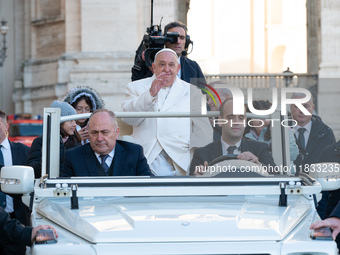 Pope Francis waves to pilgrims during the weekly general audience in St Peter's Square at the Vatican on December 4, 2024. (