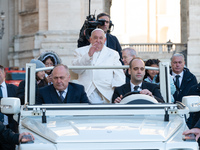 Pope Francis waves to pilgrims during the weekly general audience in St Peter's Square at the Vatican on December 4, 2024. (