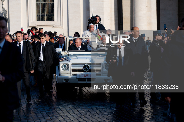 Pope Francis waves to pilgrims during the weekly general audience in St Peter's Square at the Vatican on December 4, 2024. 