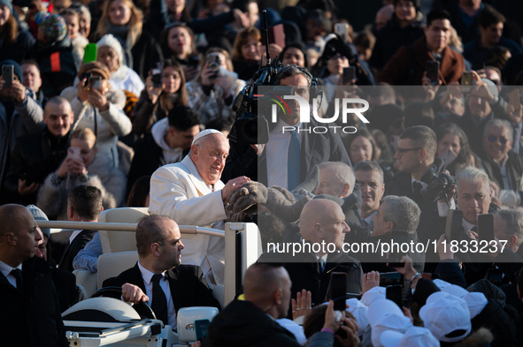 Pope Francis waves to pilgrims during the weekly general audience in St Peter's Square at the Vatican on December 4, 2024. 