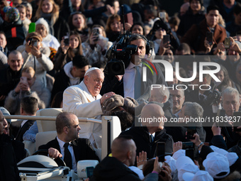 Pope Francis waves to pilgrims during the weekly general audience in St Peter's Square at the Vatican on December 4, 2024. (