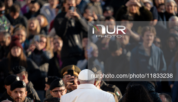 Pope Francis waves to pilgrims during the weekly general audience in St Peter's Square at the Vatican on December 4, 2024. 