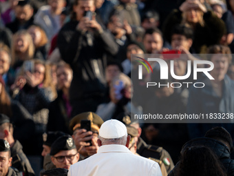 Pope Francis waves to pilgrims during the weekly general audience in St Peter's Square at the Vatican on December 4, 2024. (