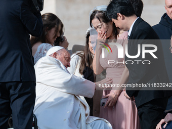 Pope Francis blesses a pregnant woman during his weekly general audience in St. Peter's Square at The Vatican, on December 4, 2024. (