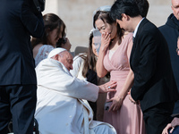 Pope Francis blesses a pregnant woman during his weekly general audience in St. Peter's Square at The Vatican, on December 4, 2024. (