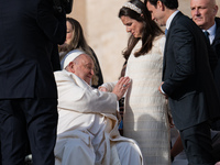 Pope Francis blesses a pregnant woman during his weekly general audience in St. Peter's Square at The Vatican, on December 4, 2024. (