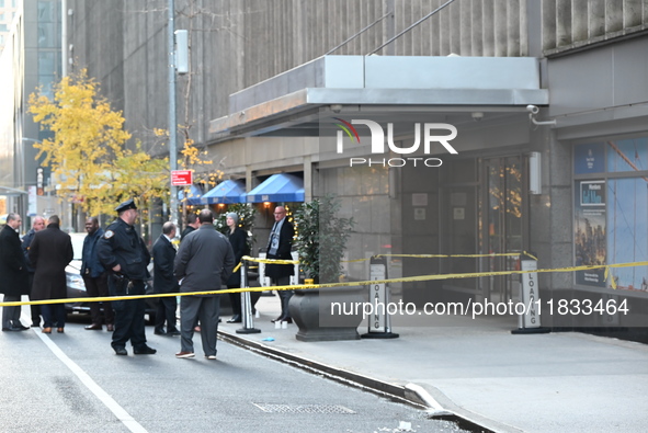 Police cover evidence with paper cups as as CEO of UnitedHealthcare Brian Thompson, 50, was shot as he entered the New York Hilton after 6:4...