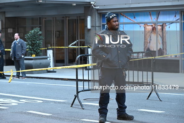 Police cover evidence with paper cups as as CEO of UnitedHealthcare Brian Thompson, 50, was shot as he entered the New York Hilton after 6:4...