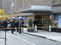 Police cover evidence with paper cups as as CEO of UnitedHealthcare Brian Thompson, 50, was shot as he entered the New York Hilton after 6:4...