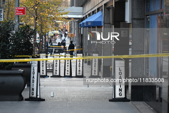 Police cover evidence with paper cups as as CEO of UnitedHealthcare Brian Thompson, 50, was shot as he entered the New York Hilton after 6:4...