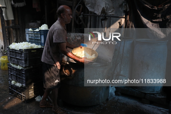 A worker prepares Indian sweet Petha inside a workshop in Kolkata, India, on December 4, 2024. 