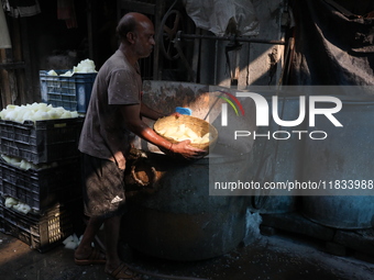 A worker prepares Indian sweet Petha inside a workshop in Kolkata, India, on December 4, 2024. (