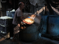 A worker prepares Indian sweet Petha inside a workshop in Kolkata, India, on December 4, 2024. (