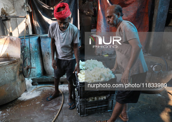 Workers prepare Indian sweet Petha inside a workshop in Kolkata, India, on December 4, 2024. 