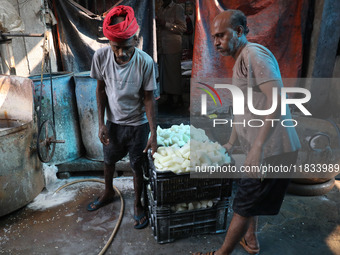 Workers prepare Indian sweet Petha inside a workshop in Kolkata, India, on December 4, 2024. (