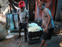 Workers prepare Indian sweet Petha inside a workshop in Kolkata, India, on December 4, 2024. (