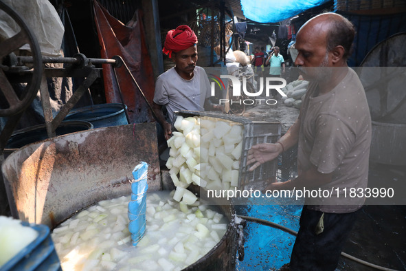 Workers prepare Indian sweet Petha inside a workshop in Kolkata, India, on December 4, 2024. 