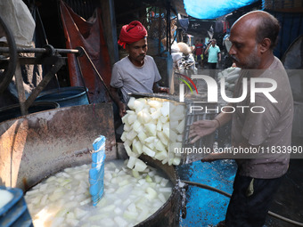 Workers prepare Indian sweet Petha inside a workshop in Kolkata, India, on December 4, 2024. (