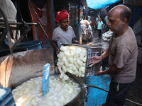 Workers prepare Indian sweet Petha inside a workshop in Kolkata, India, on December 4, 2024. (