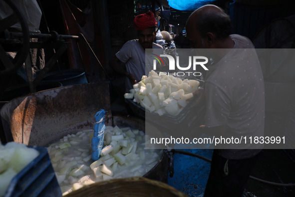 Workers prepare Indian sweet Petha inside a workshop in Kolkata, India, on December 4, 2024. 