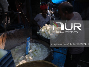 Workers prepare Indian sweet Petha inside a workshop in Kolkata, India, on December 4, 2024. (