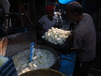 Workers prepare Indian sweet Petha inside a workshop in Kolkata, India, on December 4, 2024. (