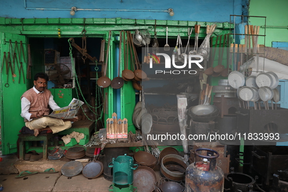 A vendor waits for his customers in his aluminum and iron utensils shop in Kolkata, India, on December 4, 2024. 