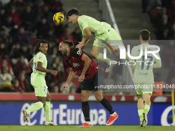 Pau Cubarsi centre-back of Barcelona and Spain and Vedat Muriqi centre-forward of Mallorca and Kosovo compete for the ball during the La Lig...