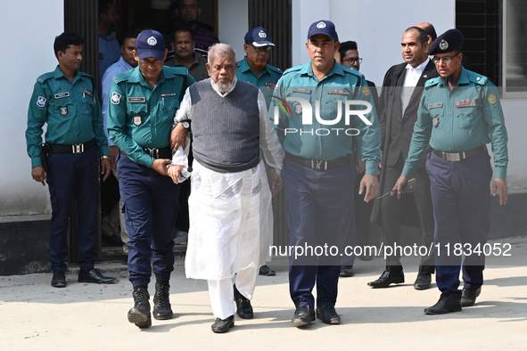 Police personnel escort detainee Amir Hossain Amu, former Minister and one of the top leaders of the Bangladesh Awami League party, to the I...