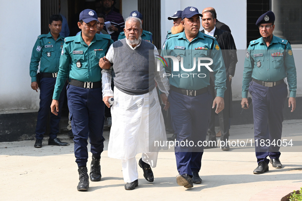 Police personnel escort detainee Amir Hossain Amu, former Minister and one of the top leaders of the Bangladesh Awami League party, to the I...