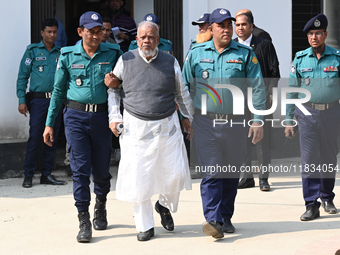 Police personnel escort detainee Amir Hossain Amu, former Minister and one of the top leaders of the Bangladesh Awami League party, to the I...