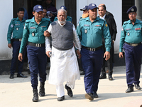 Police personnel escort detainee Amir Hossain Amu, former Minister and one of the top leaders of the Bangladesh Awami League party, to the I...