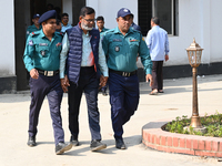 Police personnel escort detainee Abul Hossain, former chief of Jatrabari police station, to the International Crimes Tribunal (ICT) court on...