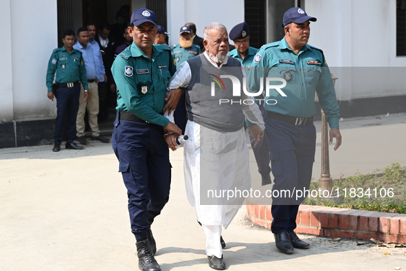 Police personnel escort detainee Amir Hossain Amu, former Minister and one of the top leaders of the Bangladesh Awami League party, to the I...