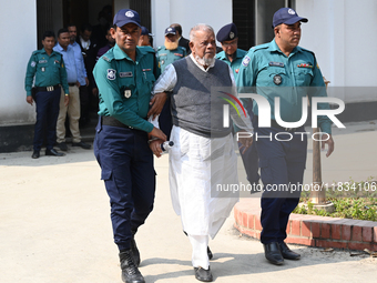 Police personnel escort detainee Amir Hossain Amu, former Minister and one of the top leaders of the Bangladesh Awami League party, to the I...