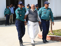 Police personnel escort detainee Amir Hossain Amu, former Minister and one of the top leaders of the Bangladesh Awami League party, to the I...