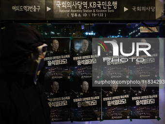 Posters featuring the face of President Yoon Suk-yeol superimposed onto the image of former military dictator Chun Doo-hwan are displayed at...