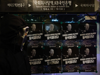 Posters featuring the face of President Yoon Suk-yeol superimposed onto the image of former military dictator Chun Doo-hwan are displayed at...