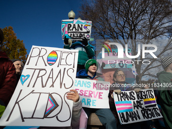 Children take part in a demonstration outside the Supreme Court as it hears a case on gender-affirming care for transgender children in Wash...