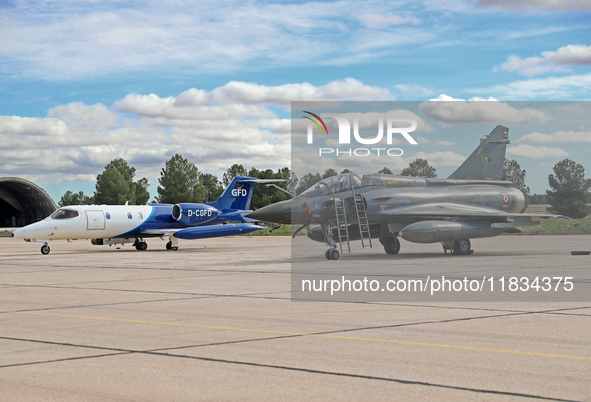 A Dassault Mirage 2000D of the French Air and Space Force and a Learjet 35A from Gesellschaft fur Flugzieldarstellung company are parked at...