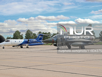 A Dassault Mirage 2000D of the French Air and Space Force and a Learjet 35A from Gesellschaft fur Flugzieldarstellung company are parked at...